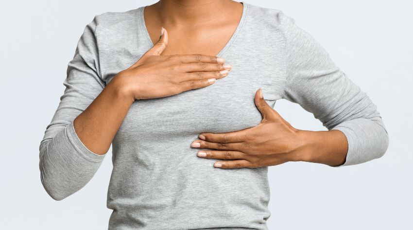 a woman concerned with breast tenderness selfe examining for breast lumps